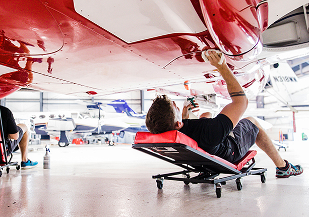 mechanic detailing a private jet