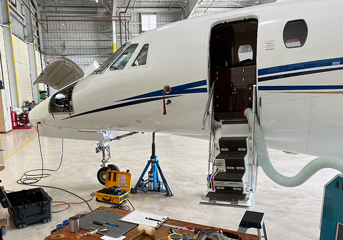 private jet inside an airplane hangar