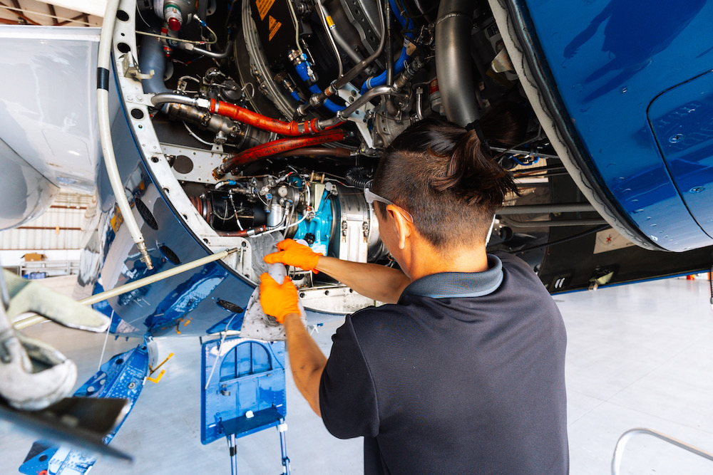 Aircraft Sales JetRx mechanic working on a private jet