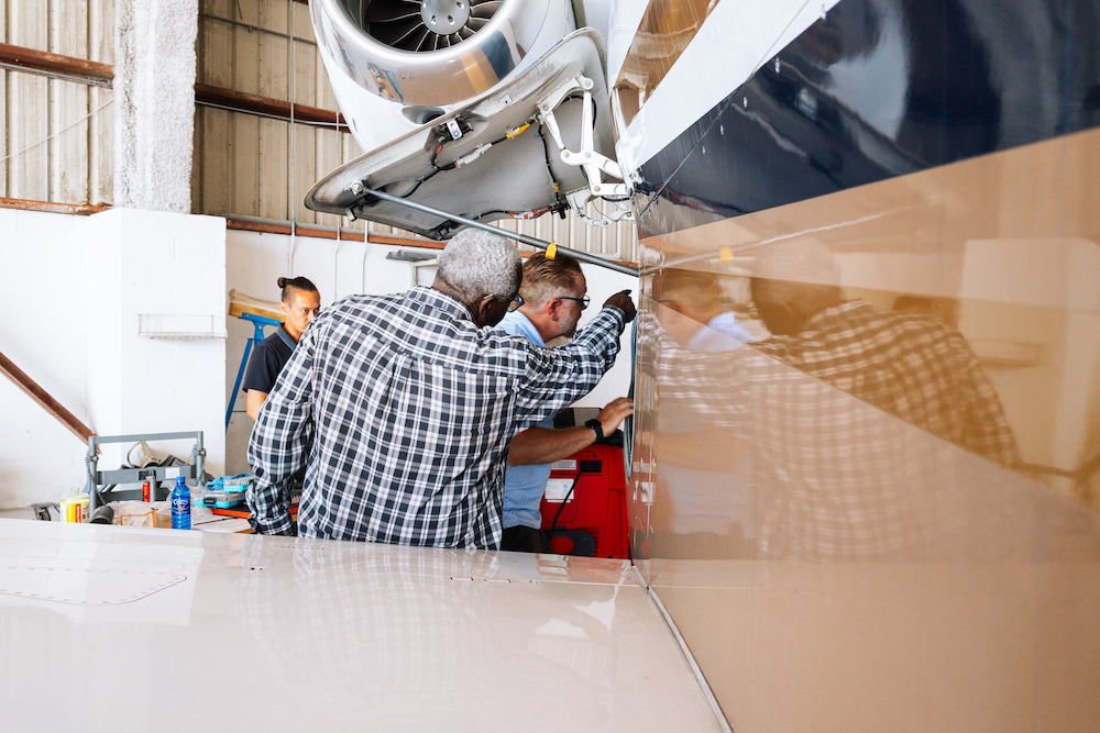 Comprehensive Inspections JetRx mechanics performing an inspection on a private jet